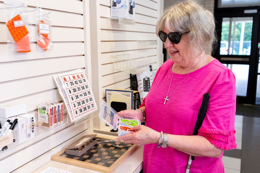 Image of woman shopping for assistive aids in the ETX Lighthouse Low Vision Store