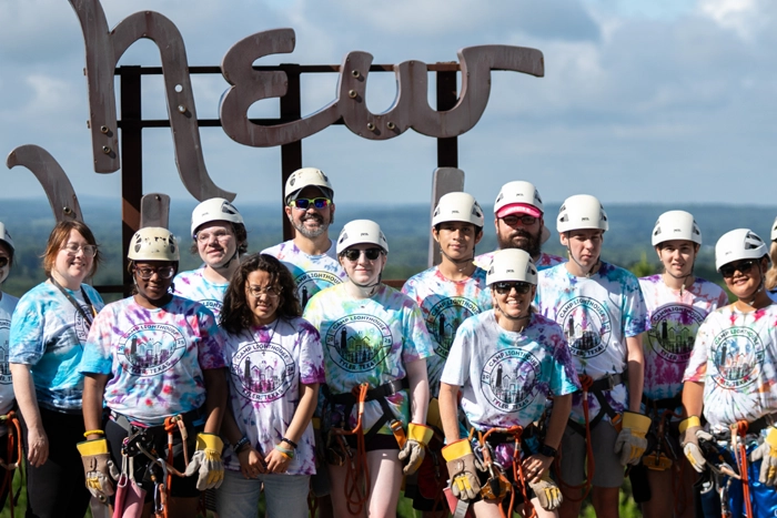 Camp Lighthouse image with students gathered at zip line event