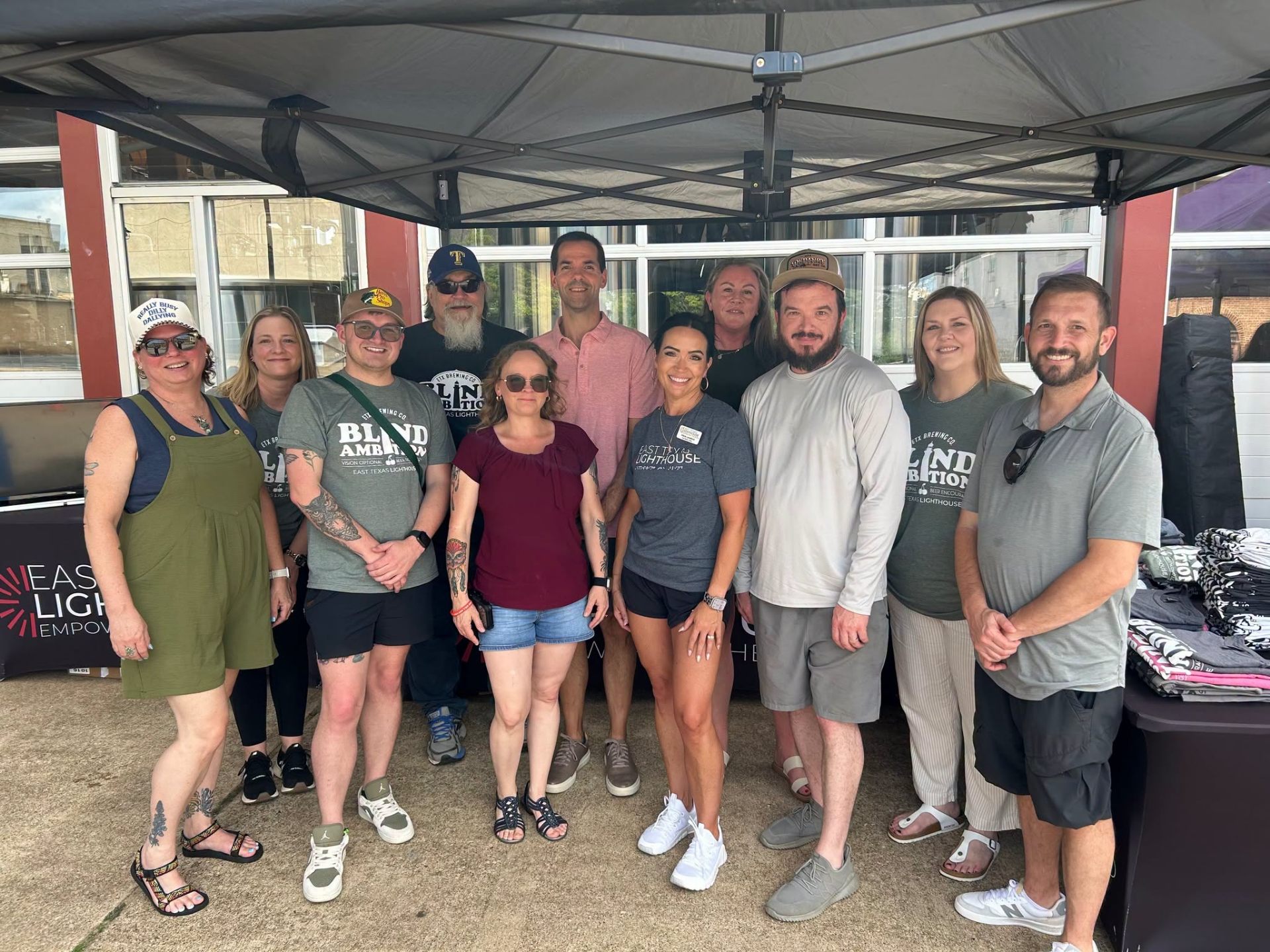 Staff and supporters gathered under a tent at the 5th Annual Blind Ambition event.